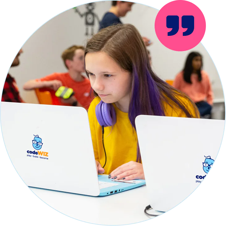 A focused girl with purple-streaked hair codes on a CodeWiz laptop