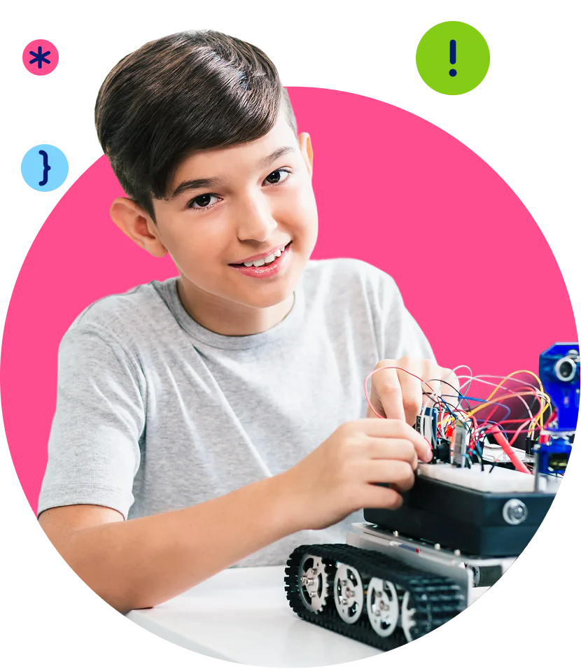 A smiling boy builds a robot with tank tracks and wires, surrounded by coding symbols.