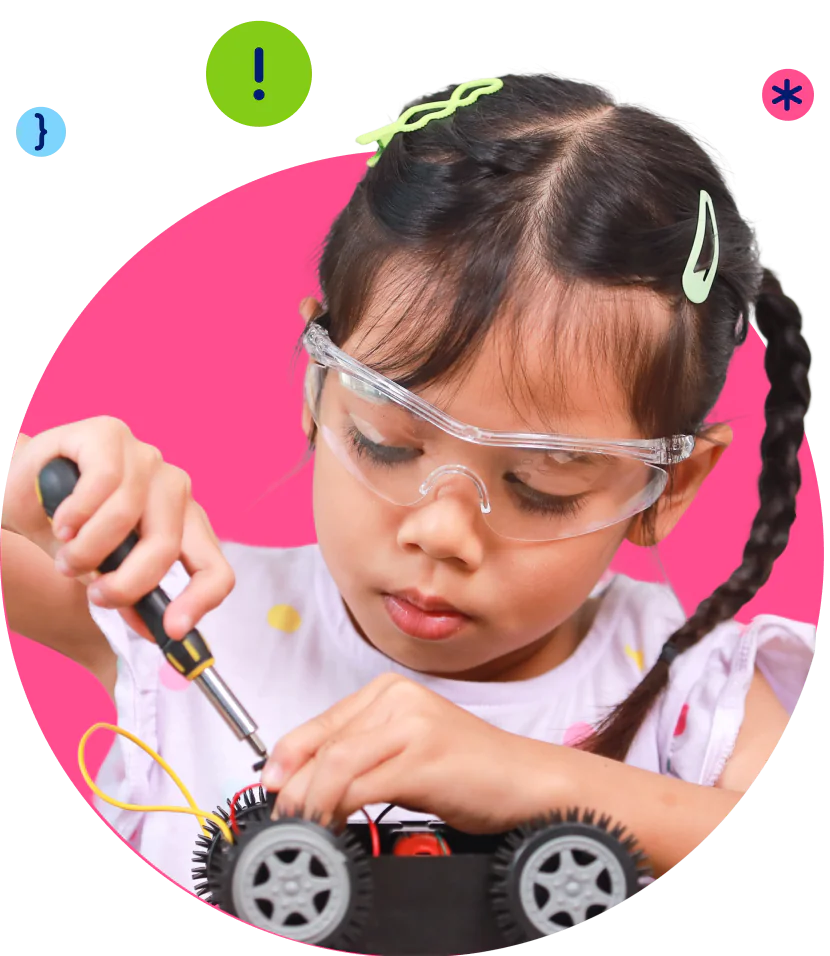 A young girl in safety glasses meticulously works on a small electronic car with a screwdriver.